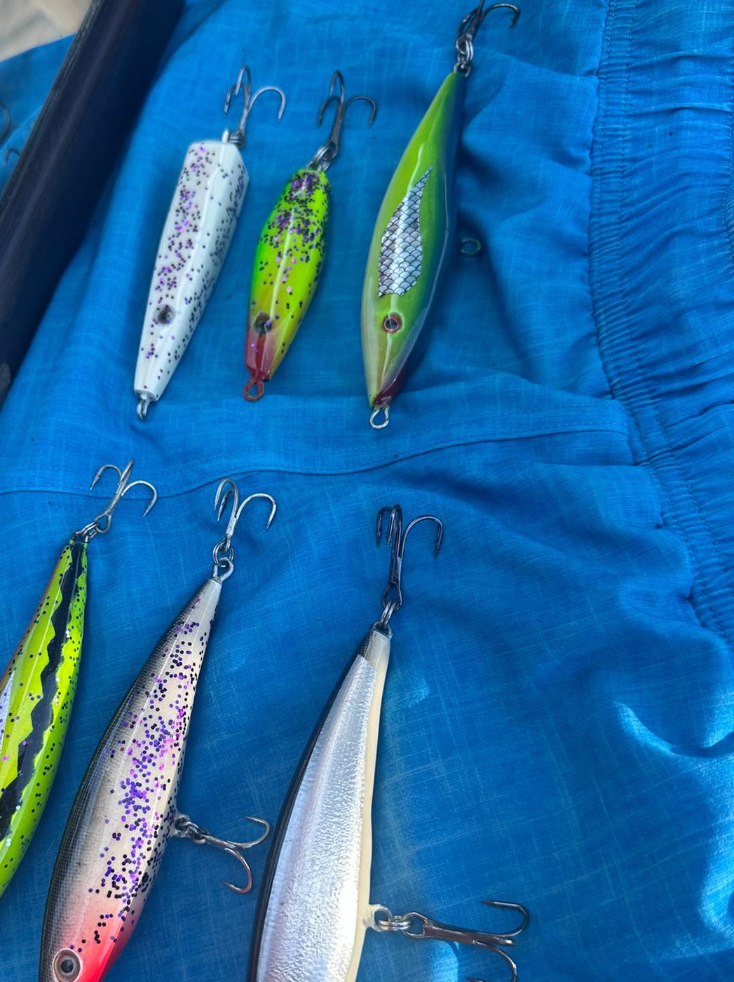 The full Chilli Boys lure lineup on the boat tarp